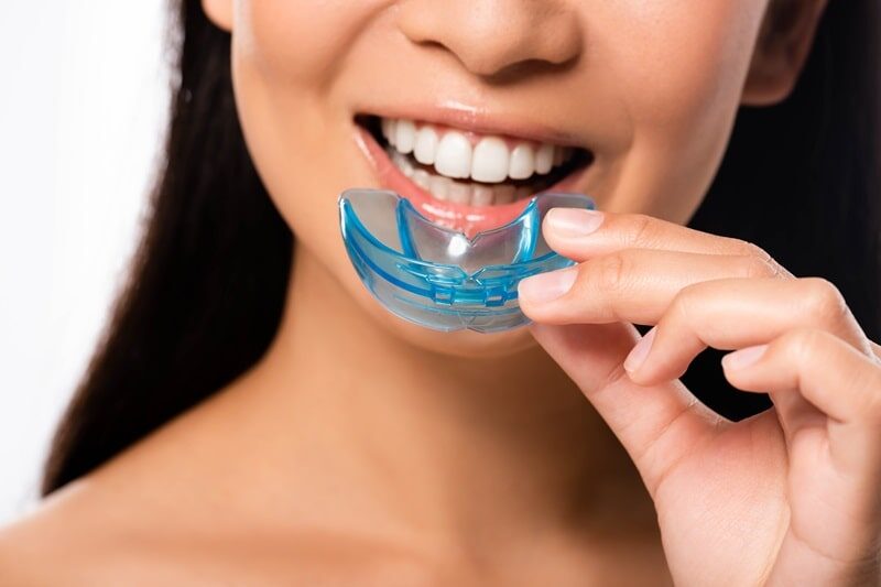 Person holding custom mouthguard